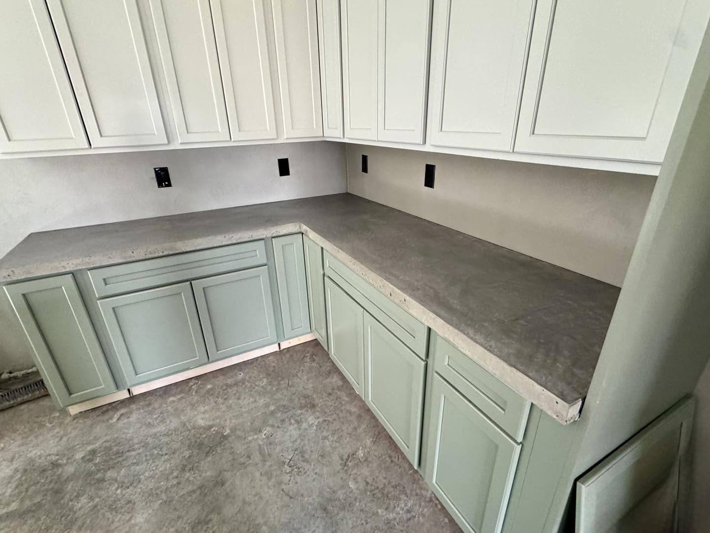 Concrete countertops with sage green cabinets in a kitchen in Winchester VA